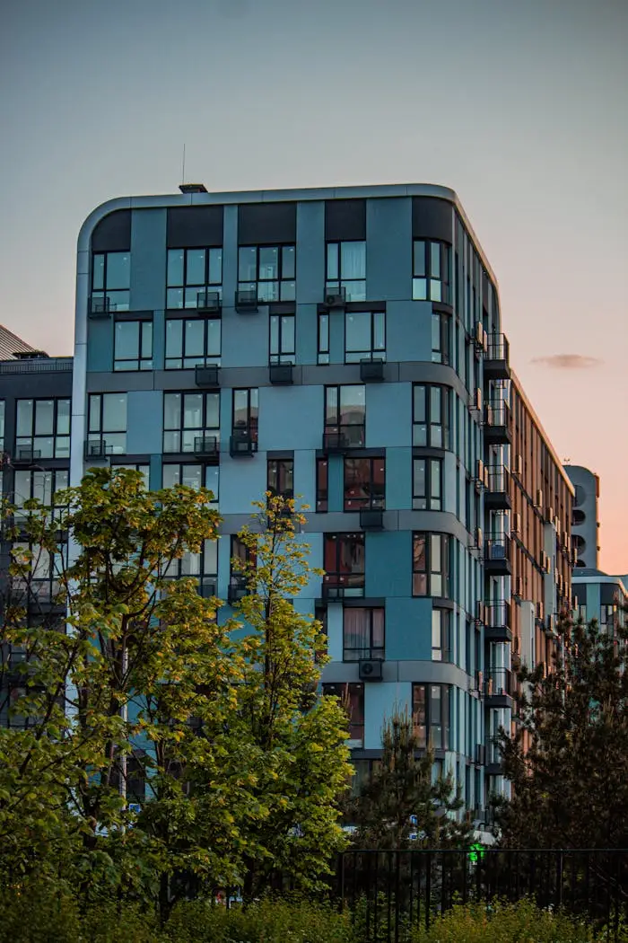 Contemporary apartment building in Kyiv during sunset, featuring modern architecture.