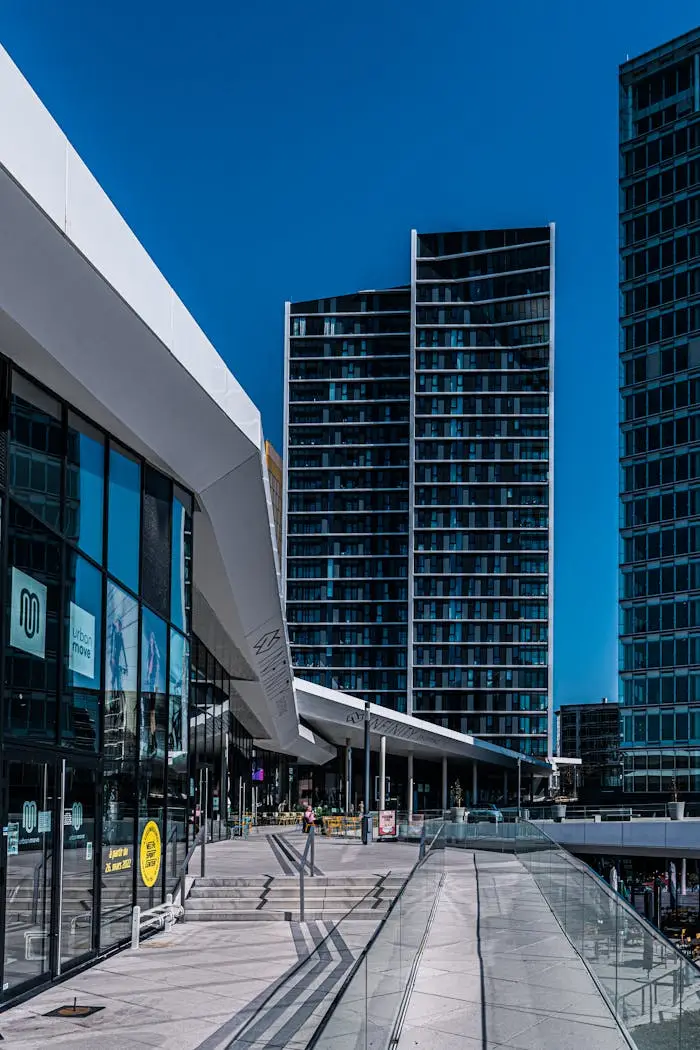 Home Contemporary urban architecture in Luxembourg with sleek glass facades and blue sky.
